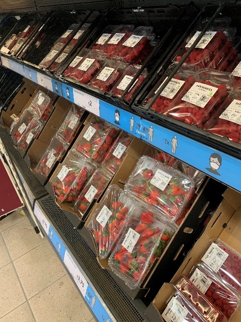 strawberries in grocery aisle